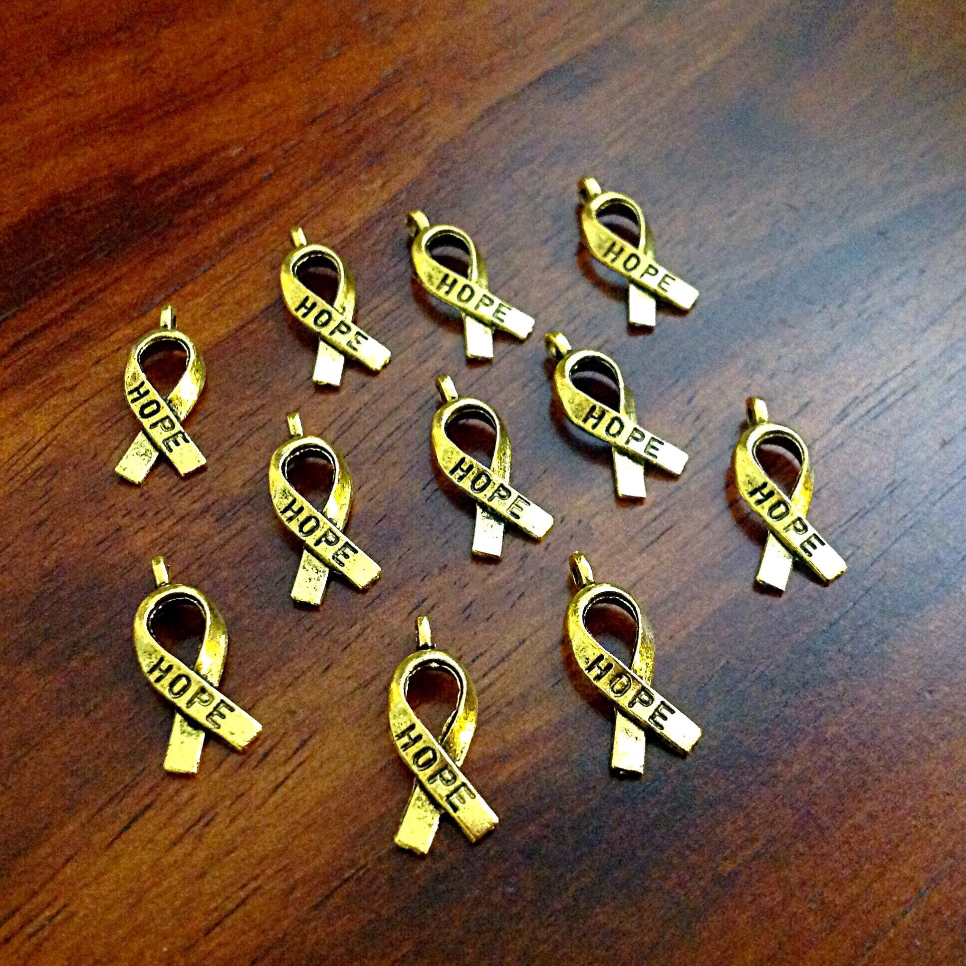 Bulk 50 Hope Ribbon Charms, Antique Gold Charms, Ribbon Charms, Hope Ribbon Charms, Awareness Charms, Jewelry and Craft Supplies, Findings